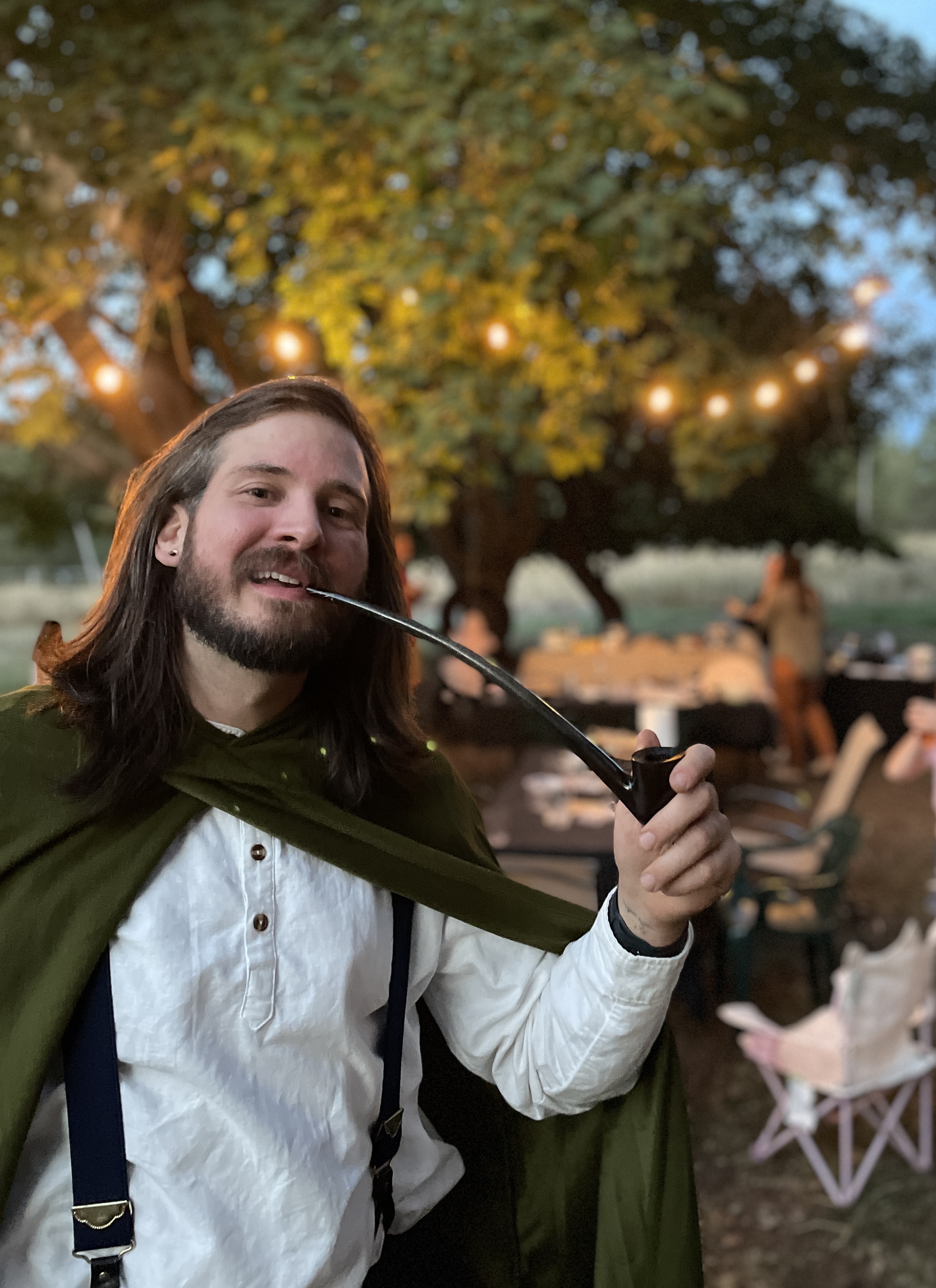 A tall guest in hobbit costume at the farm celebration